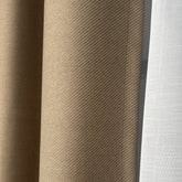 Close-up of beige, brown, and white textured fabric swatches.